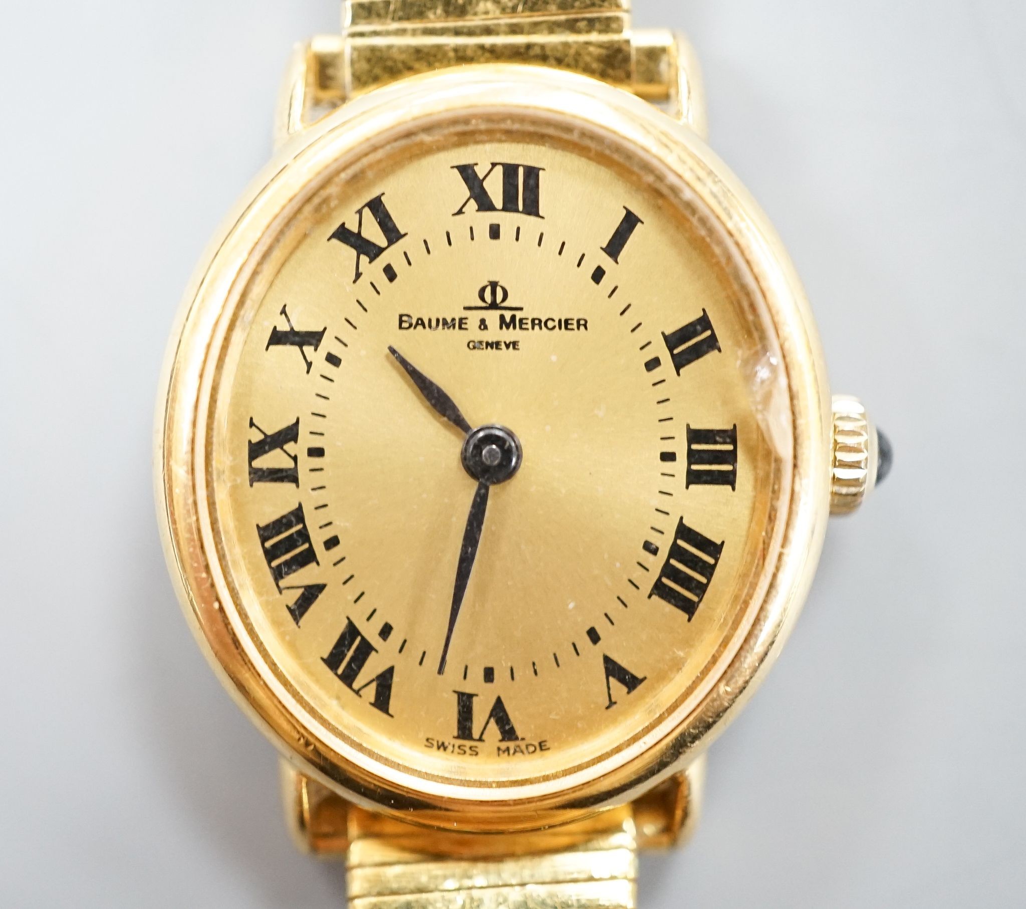 A lady's 18ct gold Baume & Mercier manual wind dress wrist watch, on an associated gold plated bracelet, case diameter 23mm, gross weight 28.3 grams.